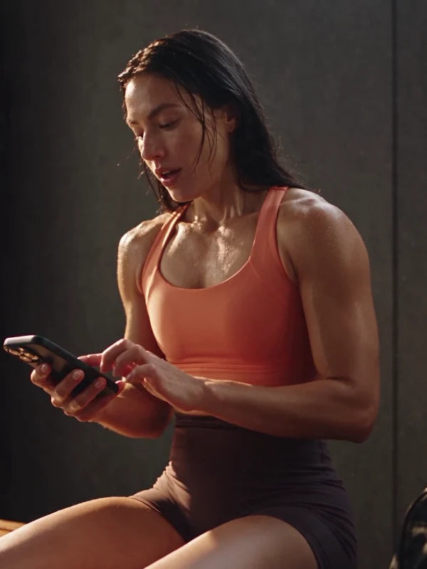 Athlete taking a break on a gym bench after a workout